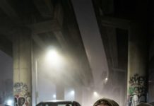 I was drifting in and out on the back seat, one hand on my belly, the other clawing at air. “Hold on, babe—we’re almost there,” my husband whispered, but his voice sounded… wrong. Then the car stopped. “Where are we?” I croaked. He didn’t answer. He opened the door, shoved me into cold alley light, and said, “I’m sorry. Don’t look for me.” I woke to screams—mine—on a filthy mattress in the slums. A baby girl cried. My baby. And somewhere in the dark, I heard his footsteps running. I swore through tears, “You will collapse… and I will watch it happen.”