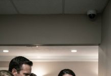 “They shoved the paper into my shaking hands while my husband’s coffin was still in the next room. ‘Sign it,’ my mother-in-law hissed, ‘or leave with nothing.’ Through my tears, I signed—and they smiled like they’d already buried me too. But when my brother-in-law laughed, ‘It’s done,’ I looked straight at the corner camera and whispered, ‘No… now it begins.’ They had no idea that signature would destroy them.”