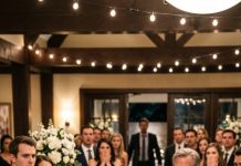 At my brother’s engagement party, I was eight months pregnant when my dad handed my BMW keys to his fiancée and said, “She needs it more than you.” I demanded them back. His face twisted with rage, and seconds later, a heavy camera tripod slammed into my head. I hit the table, bleeding, as my water broke. I called my husband—and twenty minutes later, everyone froze when he walked in…