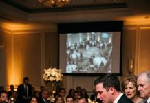 At my brother’s wedding, he accused my innocent daughter of stealing his new iPhone in front of 200 guests. I stood up and said, “She didn’t take anything.” Furious, he slammed a wooden menu board into my little girl’s head while my parents defended him. Holding her as she cried, I looked at them and whispered, “You’ll all regret this.” Five minutes later, the CCTV started playing.