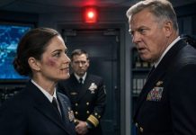 Admiral Morrison’s fist cracked against my cheek, and the room went deathly still. He expected fear. Obedience. Maybe tears. Instead, I tasted blood and smiled. “Sir,” I whispered, watching his confidence fracture, “you should’ve checked my file before touching me.” His face hardened—until the red light above the sealed door began flashing. Someone outside had just unlocked a truth even he wasn’t cleared to know.