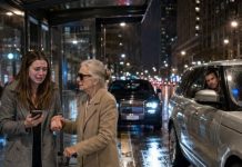 My husband left me at a bus stop with nothing but a dead phone and his cruel words: “This will teach you a lesson.” Then a blind old woman touched my hand and whispered, “Call me Grandma. My driver is coming. By sunrise, he’ll be begging you to forgive him.” I laughed through tears—until a black Rolls-Royce stopped beside us, and she said, “Now, let’s ruin your husband’s empire.”