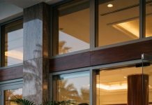 My sister blocked the entrance to a luxury hotel, laughing, “You can’t afford to step inside.” Mom grabbed my arm and whispered, “Please don’t embarrass the family.” I stared at the gold doors, then at both of them, and smiled. They had no idea I owned the entire building—and when my security chief walked toward us, their laughter died before he even spoke.