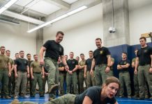 The first kick knocked the air from my lungs. The second slammed me face-first into the floor while 282 Navy SEALs watched in silence. One of them laughed, “Stay down, sweetheart.” I tasted blood, smiled, and whispered, “You should’ve checked who trained me.” Ten seconds later, both men were screaming on the ground… and the commander finally stepped forward.