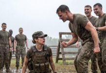 They thought the drill was the perfect place to break me. Three of them hit hard, laughing as I dropped to one knee in the mud. “Stay down, sweetheart,” one sneered. I looked up, blood on my lip, and whispered, “You just failed the real test.” Then the Navy SEAL commander stepped forward, his face ice-cold—and what happened next ended their careers on the spot.