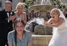 I arrived at my sister’s wedding wearing the same old dress she had mocked for years. She wrinkled her nose and sneered, “She reeks of poverty.” Then she shoved me into the fountain, laughing, while our parents clapped. “It’s just a joke,” they said. Soaked but smiling, I stepped out, raised the microphone, and glanced at the lawyer waiting beside the stage. “You’re right,” I whispered. “Now let’s see who laughs last.”