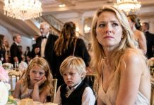 “Mom, are we not family anymore?” my eight-year-old son whispered from a tiny table beside the kitchen doors. Across the ballroom, every other grandchild sat beneath a golden sign reading “FAMILY,” while my brother raised his glass and smirked. I was ready to leave quietly—until a hotel employee handed me a hidden folder containing a forged signature, a stolen fortune, and a plan designed to erase my children forever…
