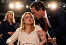 My husband wheeled me onto his campaign stage like a broken trophy, pinching my bruised arm as ten thousand voters applauded. “Smile, you drooling idiot,” he whispered. “You’re only useful as my family-man prop.” I kept smiling, even as blood soaked my sleeve. Then my one working finger touched the hidden switch—and the giant screen behind him suddenly went black.