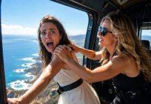 My sister smiled from the helicopter door and said, “Just lean closer for the photo.” Then her hands hit my shoulders, and I fell into the sky. Four days later, my husband stood beside my coffin, ready to collect five million dollars. He whispered, “She was too weak to survive.” That was when the church doors opened… and I walked in alive.