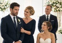 “The wedding wasn’t my choice,” I whispered as my parents celebrated the promised $500,000. I abandoned the woman I had loved for four years and married a stranger paralyzed from the waist down. One year later, my wife locked our bedroom door, slowly rose from her wheelchair, and said, “Your parents never told you why they sold you to my family.” Then she opened the hidden safe—and everything I believed collapsed.