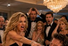 “I told you no,” I said, trying to keep my voice steady. “You want to bring your ex to our anniversary gala?” Before I could finish, my wife grabbed a glass of red wine and splashed it across my face. The ballroom fell silent as everyone stared. She wasn’t just angry—she looked terrified. Then I noticed her ex smiling from the entrance… like he’d been expecting this all along.