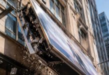 I heard the metal scream before the crowd did. “Move!” I shouted, throwing myself toward the woman in diamonds as the giant billboard tore loose above us. Her eyes widened. “Oh my God—!” I slammed into her, dragging her out of the shadow just as glass exploded behind us. I thought I was just a broke delivery driver saving a stranger… until she gripped my jacket and whispered, “You have no idea who you just saved.”