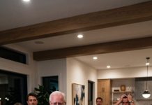 “Honey, can you turn on the living room TV?” I asked with a smile as my mother-in-law laughed beside my father-in-law. Seconds later, the hidden security footage filled the screen. There she was—wrapped in another man’s arms inside our house during our family gathering. “What… what is this?” she gasped. I looked straight at my father-in-law and said, “I think it’s time everyone watched the truth unfold.”