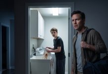 I came home two days early and found the entire house dark—except for the laundry room, where my fifteen-year-old son was scrubbing blood from a white shirt at midnight. “Please don’t tell Mom I ruined it,” he whispered. Then I saw the bruises around his wrist. When my wife walked in beside her smirking brother, she said, “Marcus is the only real man in this house.” I stayed calm—because they had no idea what the cameras had recorded.