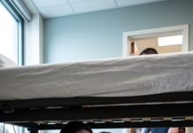 I had just given birth when my eight-year-old daughter quietly pulled the hospital curtain shut and whispered, “Mom, get under the bed. Right now.” Before I could ask why, she grabbed my arm and dragged me down. We held our breath as footsteps crept closer outside the room. Then she pressed her tiny hand over my mouth and whispered, “If they hear us… they’ll take the baby.”