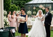 At my sister’s wedding, I found my place card taped to a folding chair beside two overflowing trash bins. She smirked, “I guess they forgot to count you.” I picked up the ivory gift box and walked away without a word. Five minutes later, the music stopped. When the bank froze her husband’s accounts, she came running after me, screaming, “What did you put in that box?”
