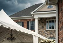 When I pulled into my driveway after a week-long business trip, wedding music echoed across my front yard. My mother-in-law pointed at me and screamed, “Get out! We’re welcoming my son’s new wife today!” My husband stood beside another woman in a white dress without a trace of guilt. I smiled, walked to the utility panel, and cut off the electricity and water. They laughed… until they discovered who truly owned the house.