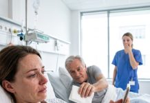 Forty-three minutes before my cancer surgery, my phone buzzed. My husband’s text read, “I want a divorce. I’m not built for a sick wife.” My world shattered before I even reached the operating room. Then the stranger in the next hospital bed quietly slid a napkin toward me. I forced a smile and whispered, “If I survive this… marry me.” He looked me in the eyes and simply replied, “Okay.” I had no idea who he really was.