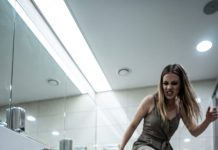 Eight months pregnant, I collapsed on the freezing bathroom tiles as blood soaked through my dress. My sister-in-law looked down at me, then drove her foot into my ribs. “Bleed to death, trash,” she laughed. “My brother’s real wife is waiting upstairs in the VIP room.” I clutched my belly, barely conscious—until the bathroom door opened and a familiar voice whispered, “Don’t move. I know what they did.”