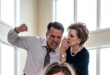 My mother-in-law leaned close to my husband and whispered, “Hit her harder. Make sure she can’t argue anymore.” His fist came down again as I tasted blood, but I didn’t scream. I only looked at her and smiled. “You really think I came here alone?” I whispered. Then the front door burst open—and the moment my husband saw who was standing there, his face went completely white.