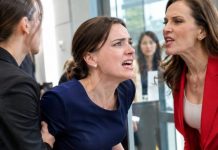 VISITING MY HUSBAND’S OFFICE, I CAUGHT HIS ASSISTANT BULLYING A WORKER. I WENT TO STEP IN, BUT A COLLEAGUE PULLED ME BACK: “SHE’S THE CHAIRMAN’S WIFE, DON’T CROSS HER!” I SMILED AT THE FAKE WIFE, READY TO EXPOSE HER SECRET.