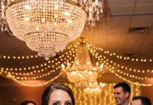 At my brother’s wedding—the very brother our mother had sacrificed everything to raise alone—she walked into the reception hall proudly wearing a name tag. Except, the elite bride and her snobbish family had maliciously replaced it to read: “Uneducated Fake Mother.” As the entire ballroom burst into cruel laughter, my mother humiliatedly turned to leave. I grabbed her hand and whispered, “Mom, we’re going home.” The next morning, their company faced a catastrophic collapse—and my phone lit up with 32 missed calls from the bride.